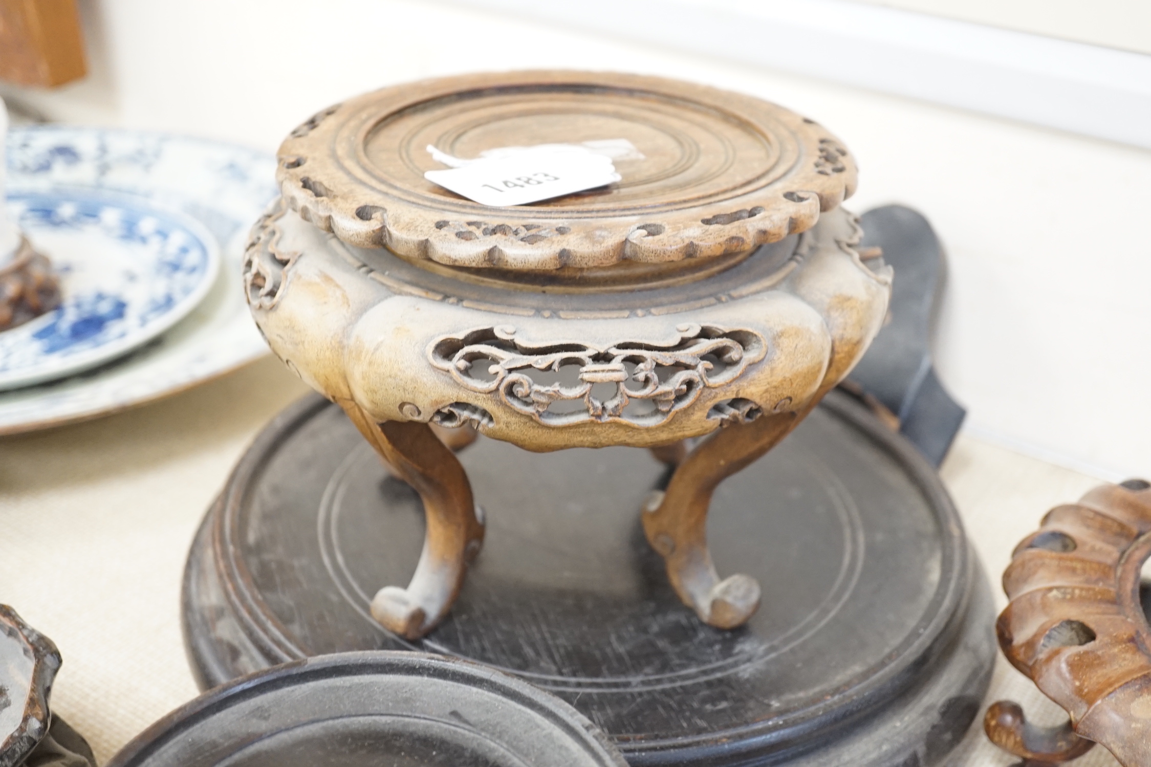 Seventeen Chinese carved wood stands of varying sizes, largest 30cm diameter